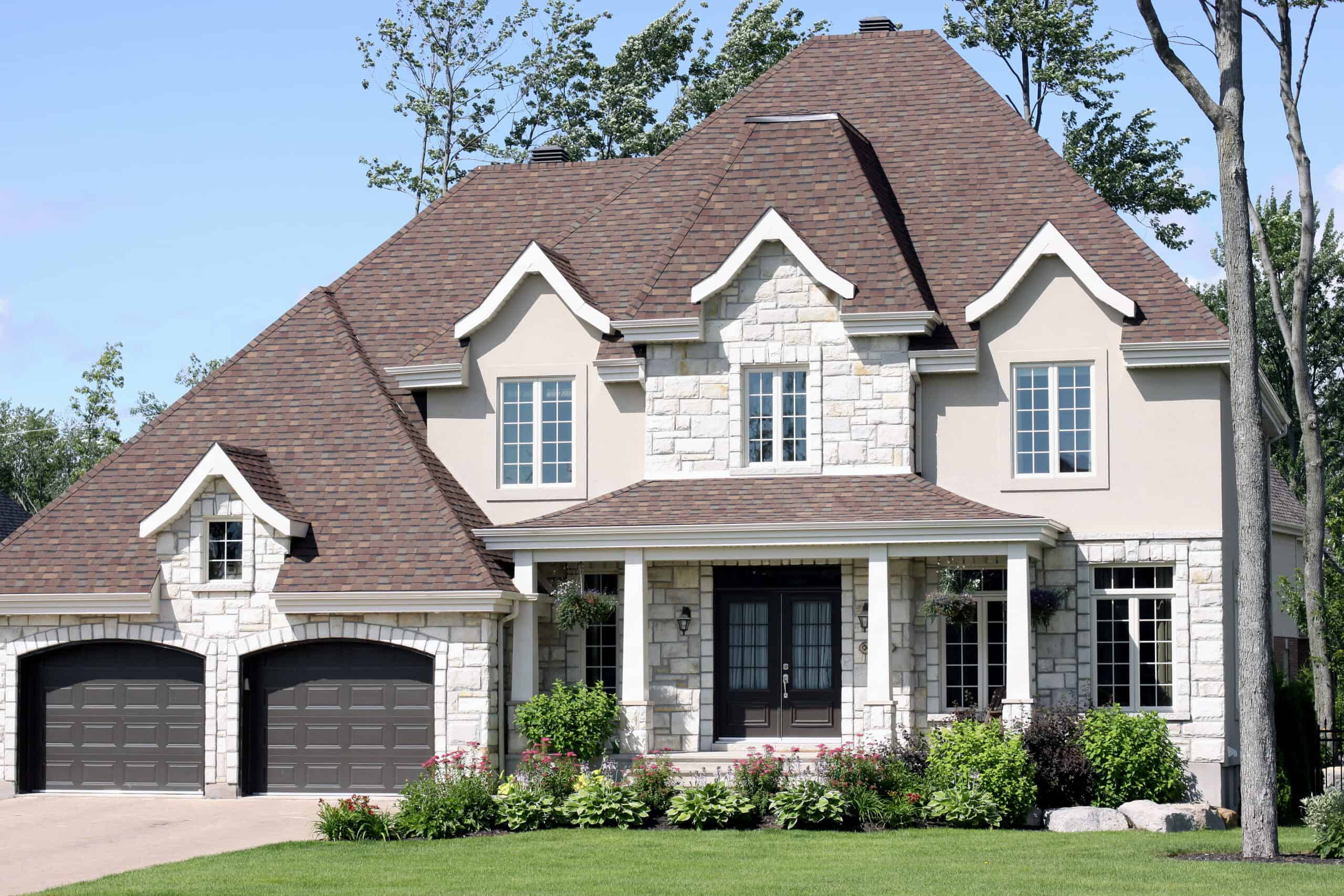 Home exterior Upscale suburban home in afternoon light with beautiful landscaping